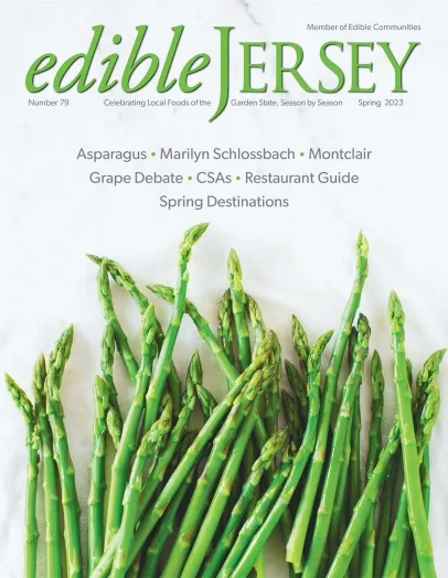 Mockup of the cover of Edible Jersey magazine, featuring a bundle of asparagus.